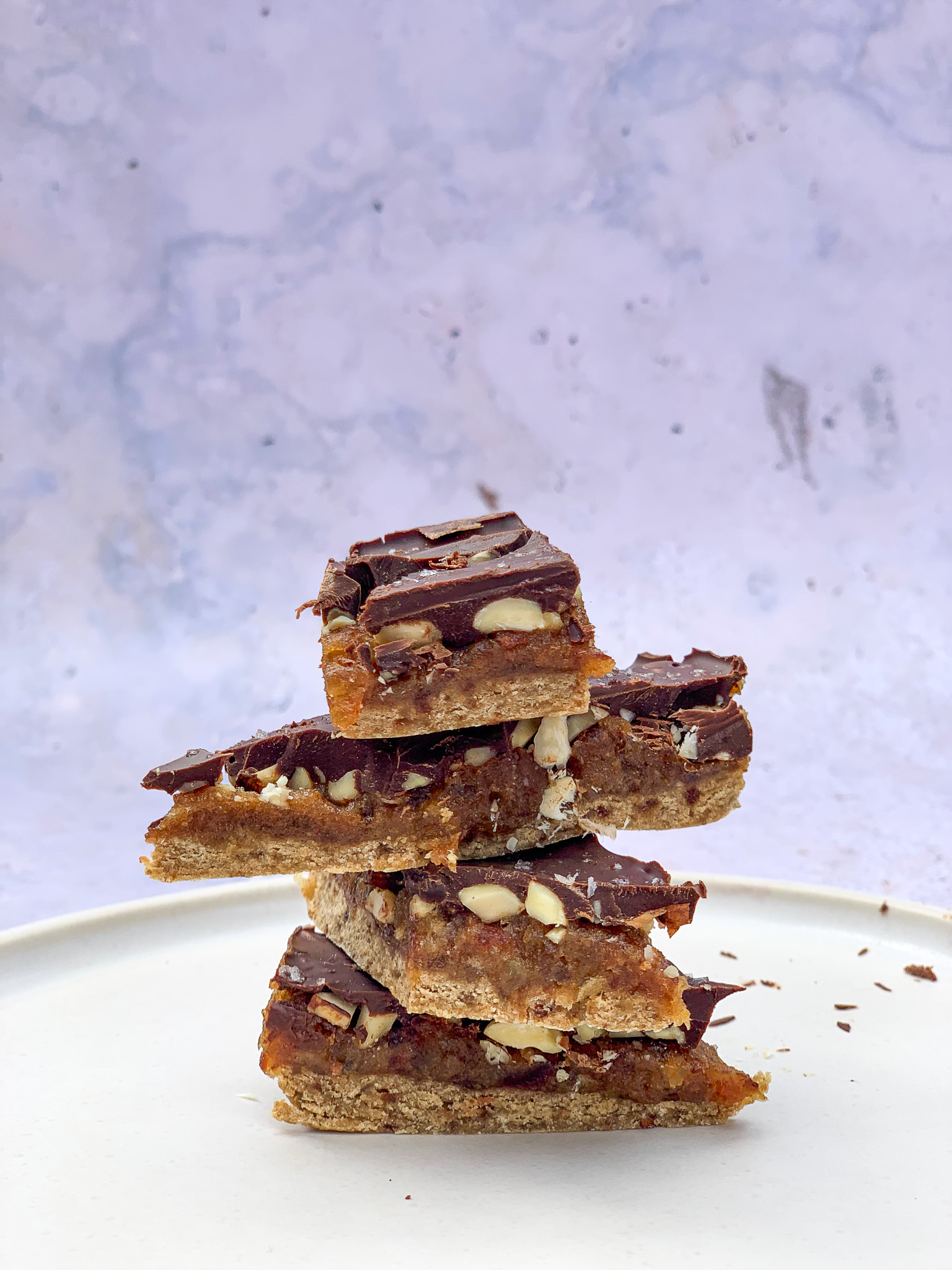 Vegan Snickers Bars stacked in a pile