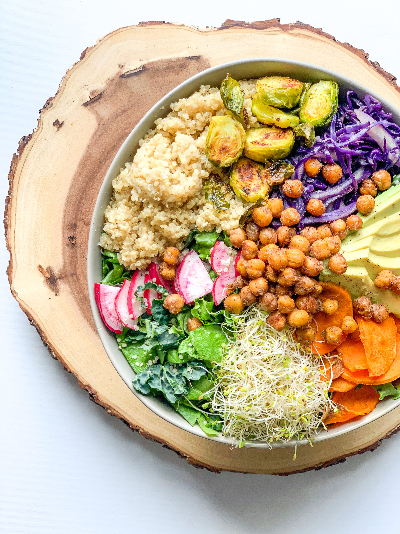 Bowl with roasted chic peas, cabbage, sprouts, and other great ingredients with Vegan Ranch Dressing